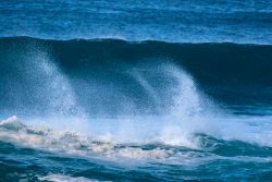 a man riding a wave on top of a surfboard