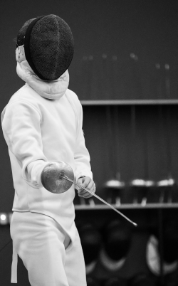 a person in a white outfit holding a stick